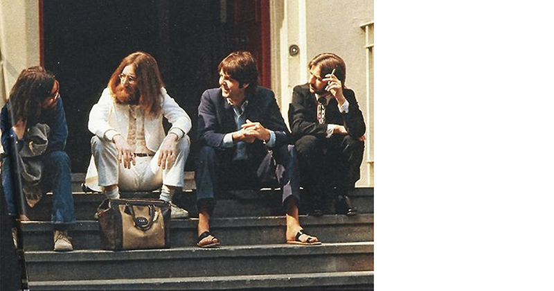 The Beatles sitting near the recording studio